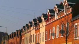 Three generations of dormer windows catch the late afternoon sun on the New Lodge Road.